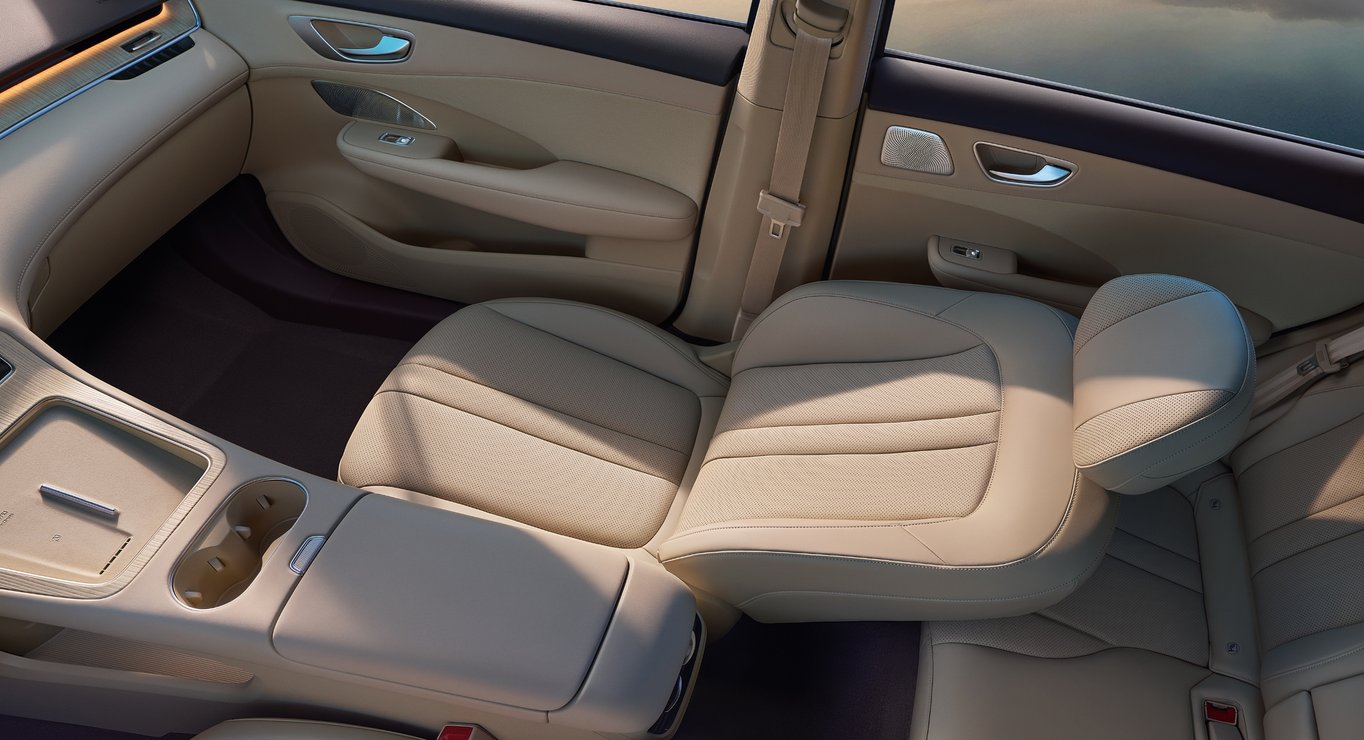 Overhead view of the front passenger side of the Shangjie H5 Radiant Apricot interior, showcasing the ergonomic seats