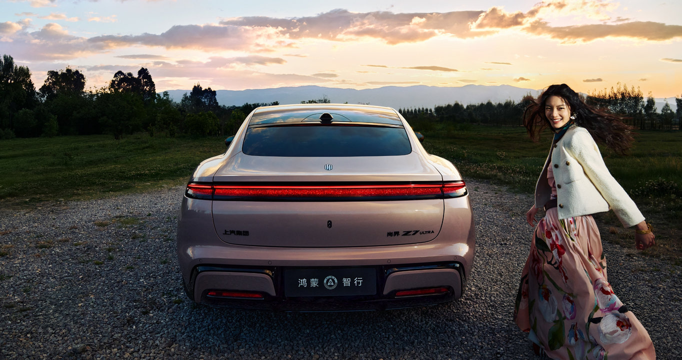 A pedestrian behind the Shangjie Z7, showing the car's rear-facing high-precision solid-state lidar braking to a stop in time.