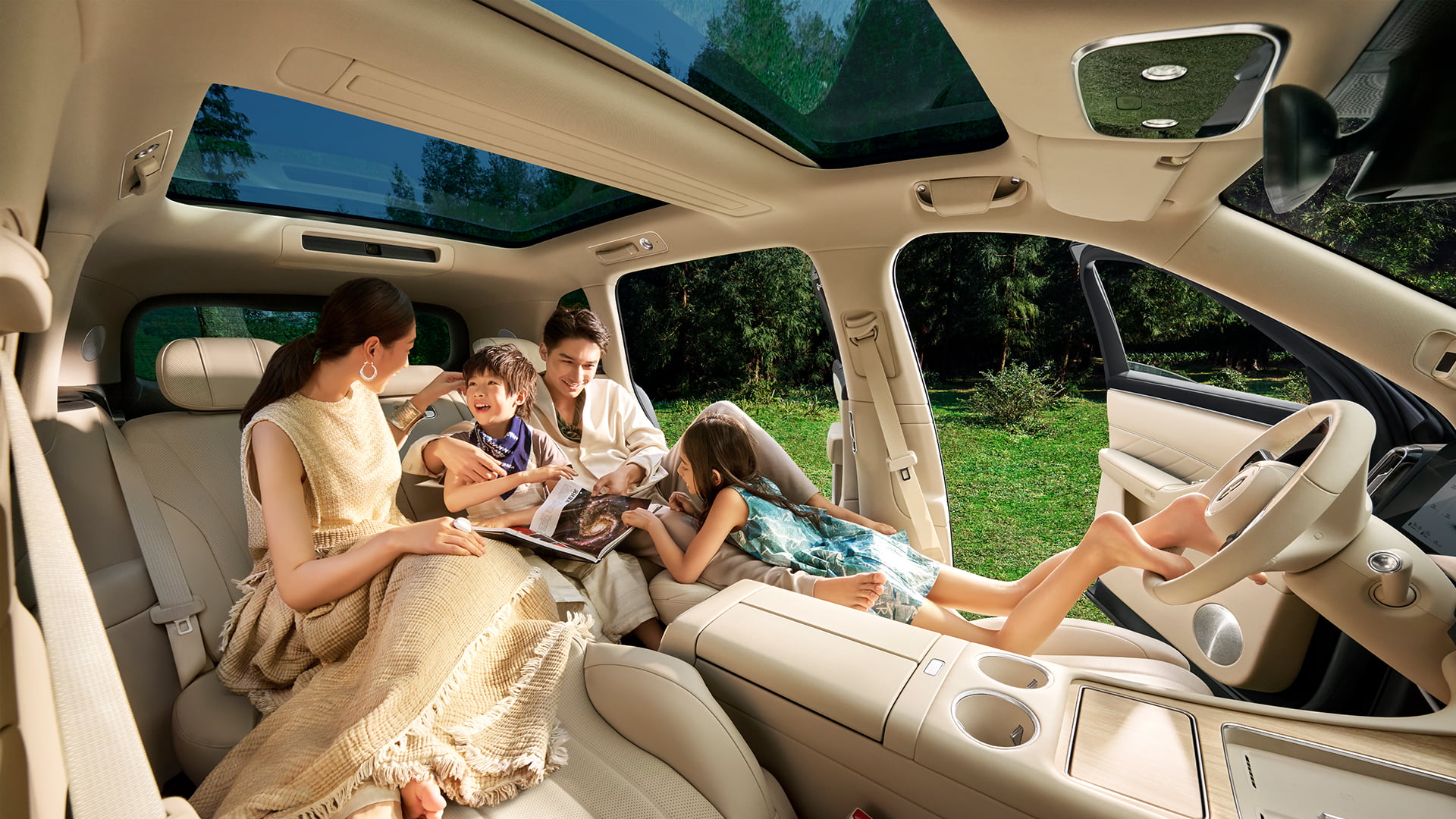 A family chatting happily inside the car, showing the open seating space across three rows