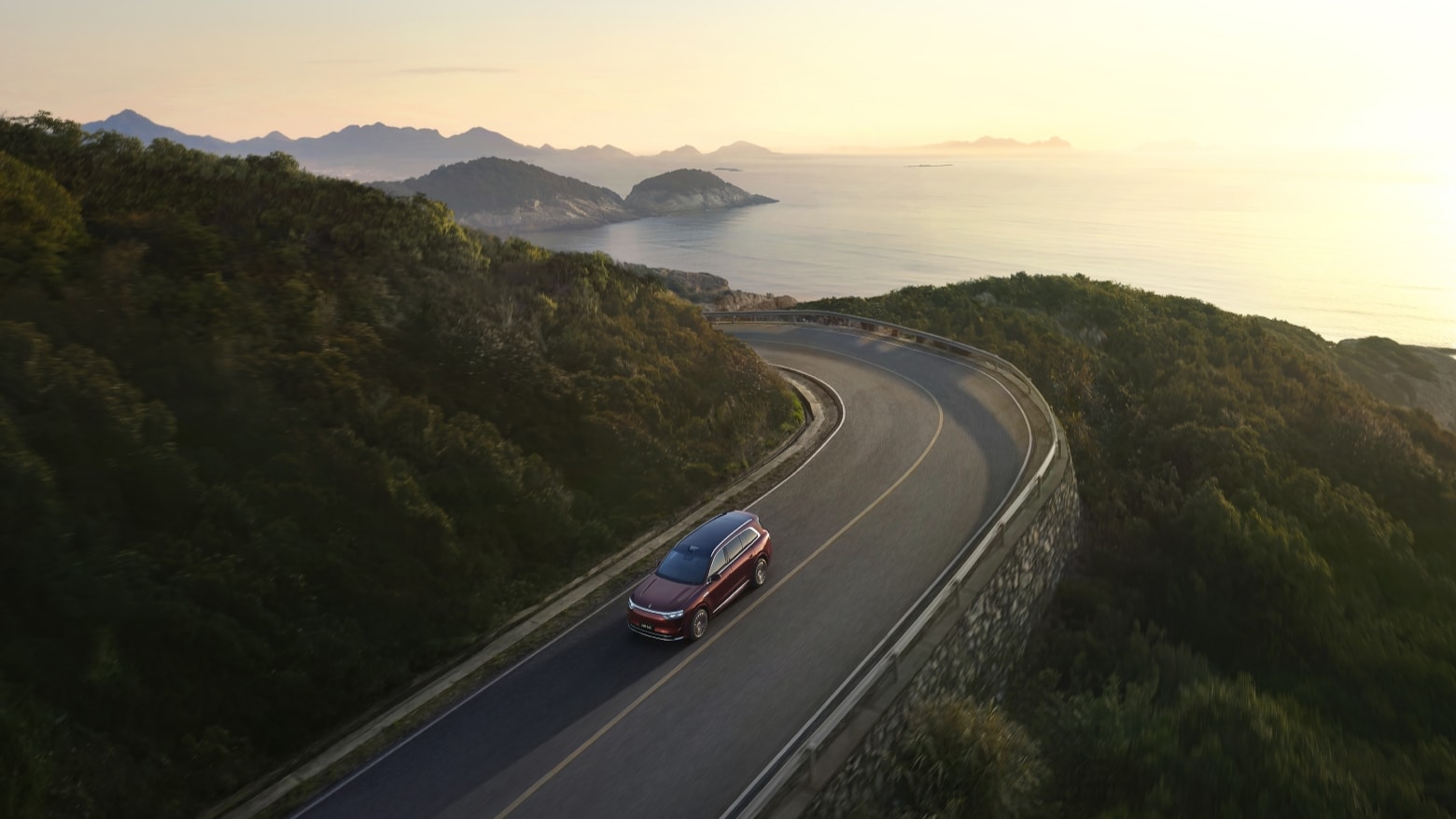 An AITO M8 in Glow driving on a mountain road