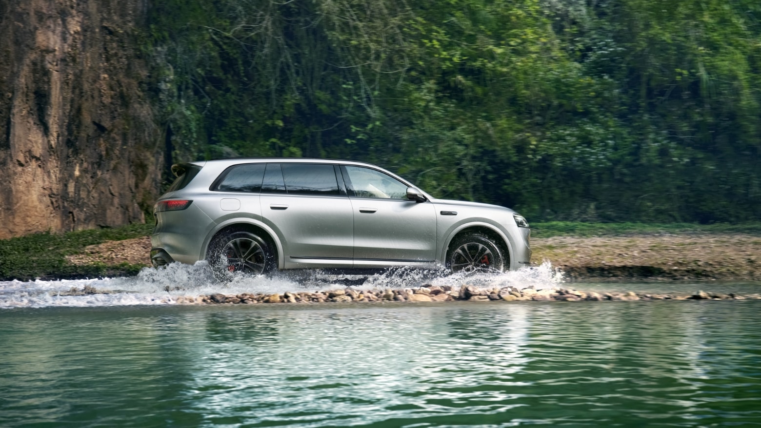 An AITO M8 in Galaxy driving on a wading road surface