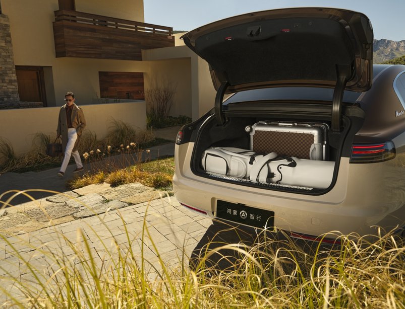 A suitcase and golf bag loaded into the Maextro S800 boot